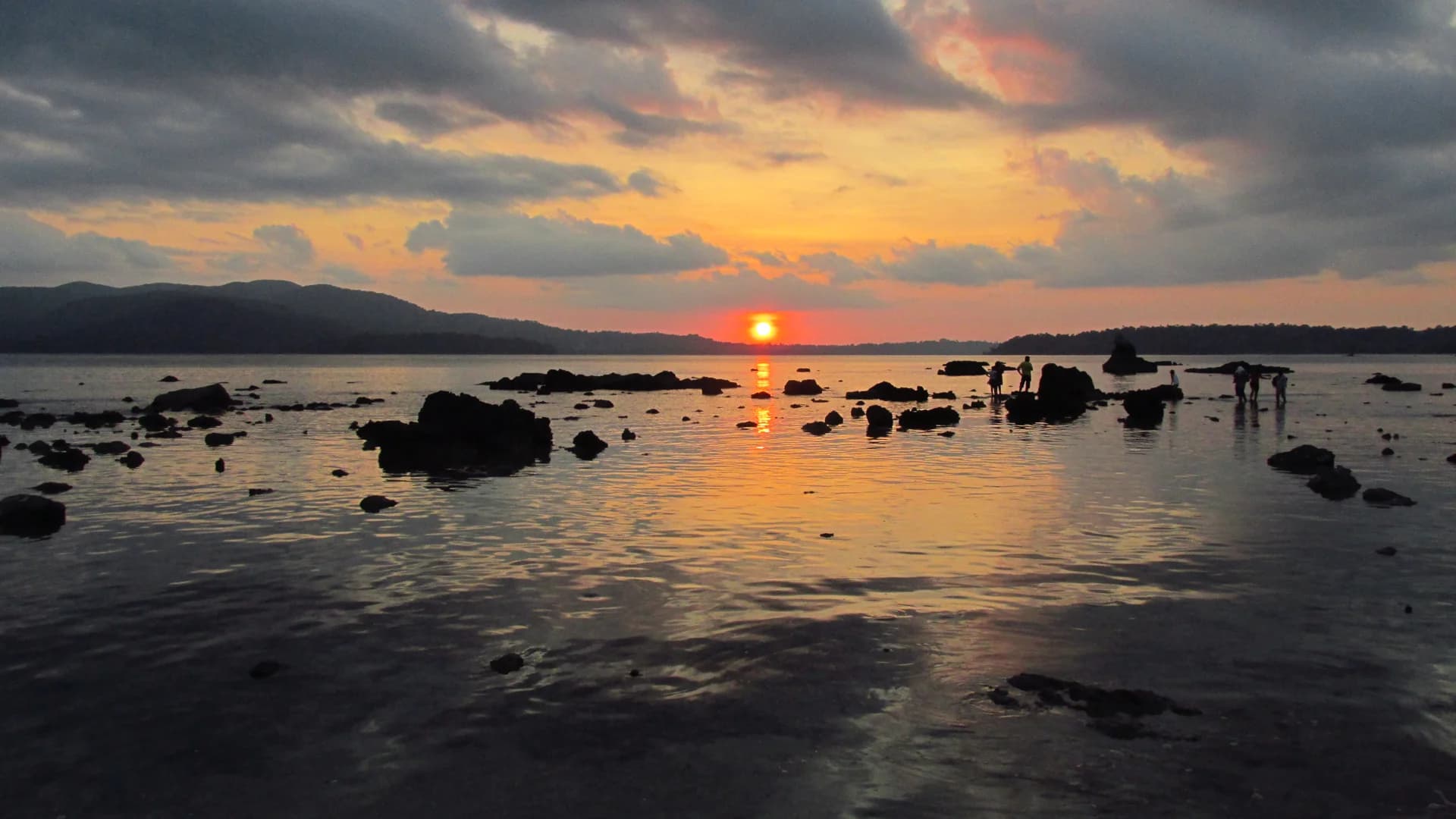 The sun setting over the sea and distant island silhouettes at Chidiya Tapu.