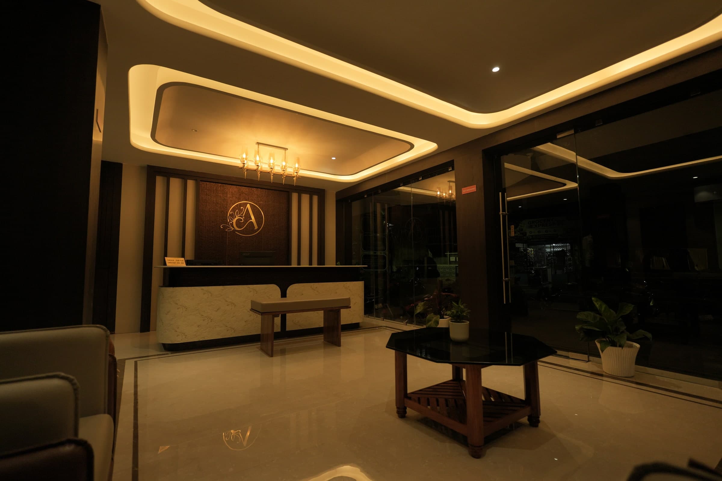 Reception and lounge seating beneath the lobby's warm ceiling lights